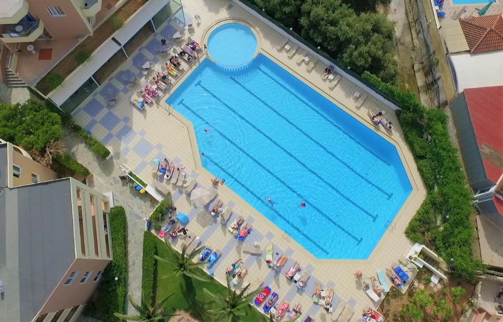 an overhead view of a large swimming pool with people at Atrion Resort Hotel in Agia Marina Nea Kydonias