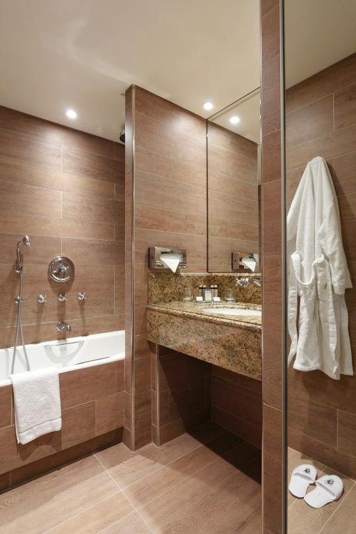 a bathroom with a sink and a mirror at Au Manoir Saint Germain in Paris