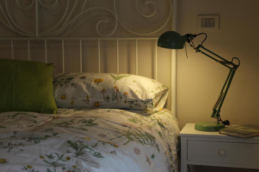 a bedroom with a bed and a lamp on a nightstand at Suite Manzoni in Rome