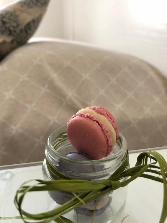 a pink dessert in a glass jar on a table at Villa Pollio Guest House in Anacapri