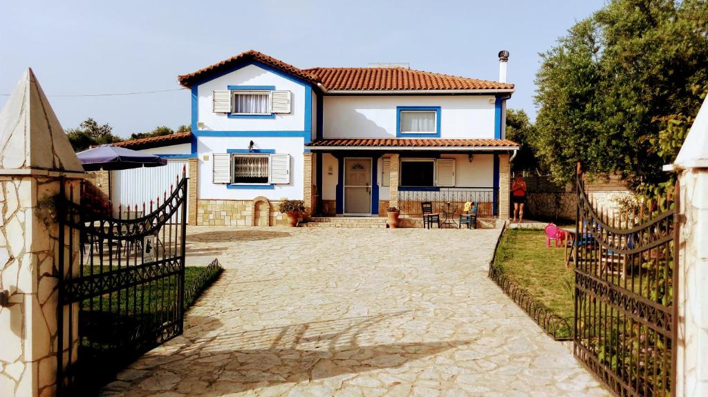 a blue and white house with a gate at Villa Julia in Tsilivi