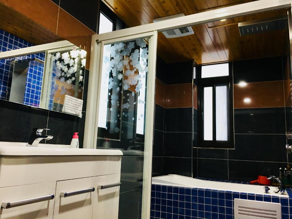 a bathroom with a sink and a shower at Sweetlight B&amp;B in Jiaoxi