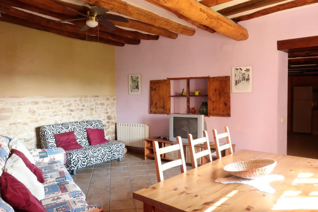 a living room with a table and a couch at Casa Celestino in Alquézar