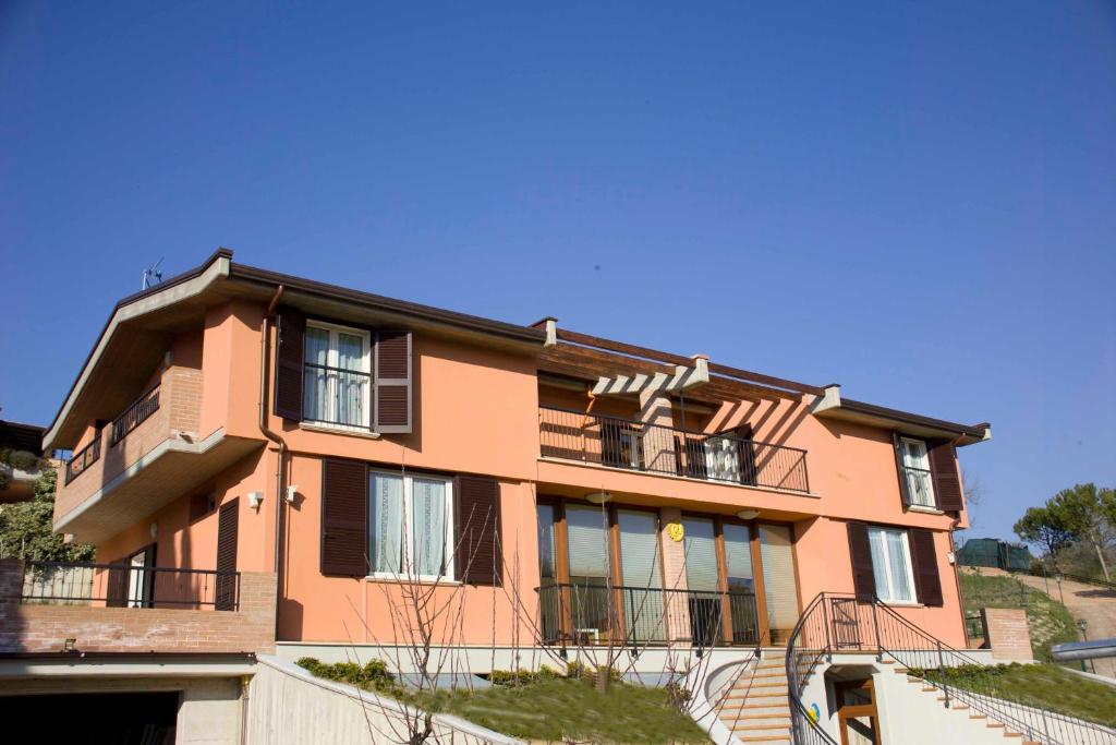 a orange house with a balcony on a hill at B&B Sole Luna in Perugia