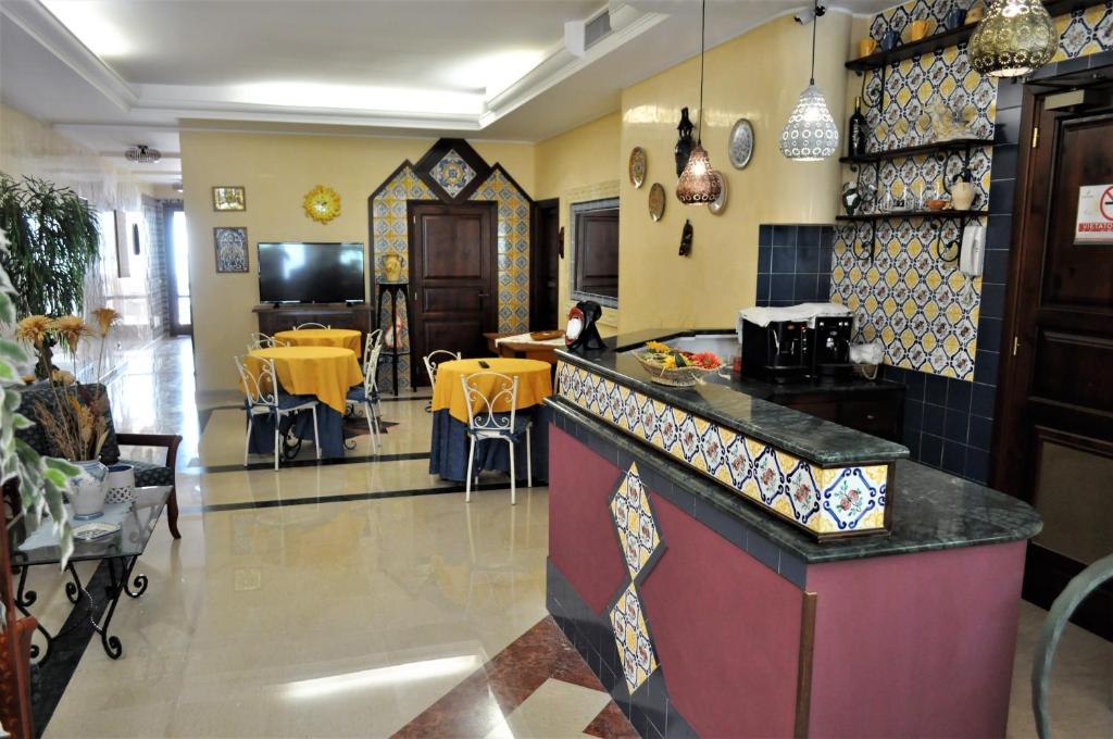 a kitchen with a counter and a dining room at Al-Tair in San Vito lo Capo