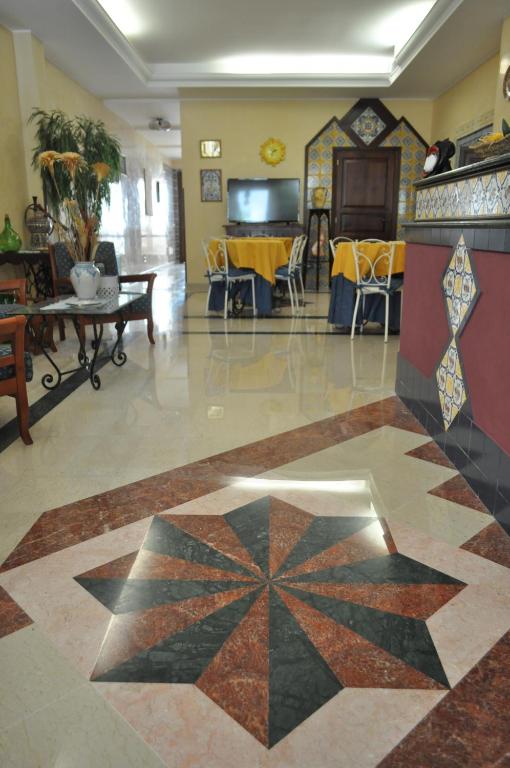 a living room with a tile floor with a star pattern at Al-Tair in San Vito lo Capo