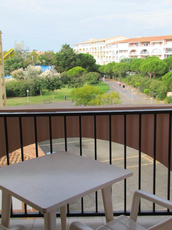a balcony with a table and a view of a street at Hotel Alhambra in Cap d&#39;Agde