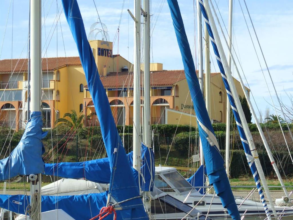 a group of boats with blue sails in a marina at Hotel Alhambra in Cap d&#39;Agde