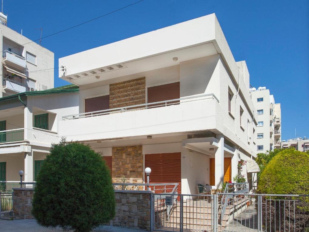 a white house with a fence in front of it at Despoina Town House in Limassol