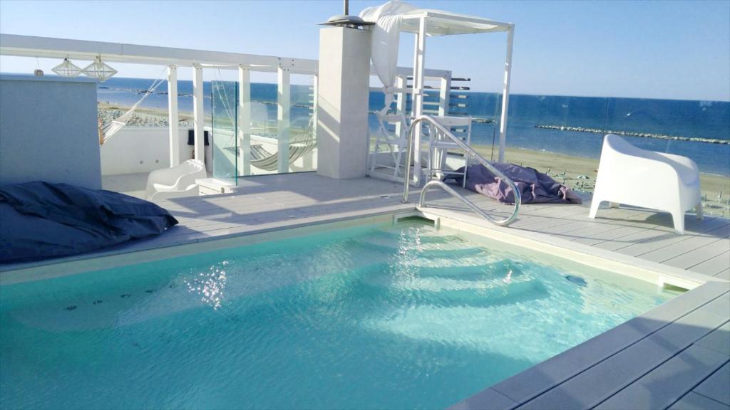 a swimming pool on the deck of a house at Hotel Madalù in Rimini