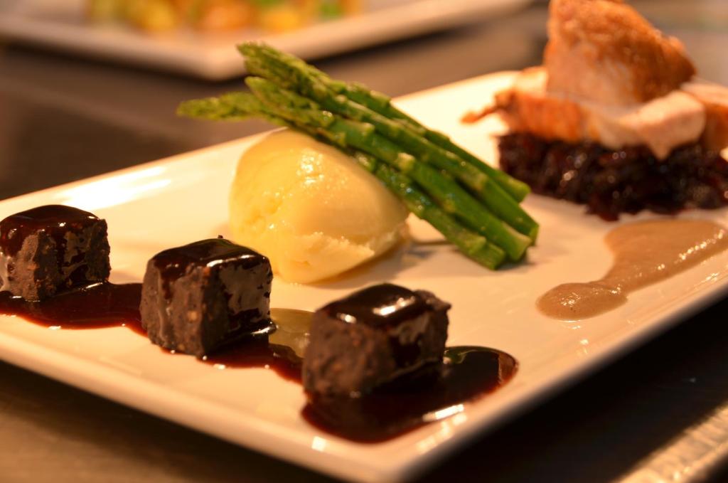 a plate of food with chocolate covered food and asparagus at The Riviera Hotel & Apartments - Alum Chine in Bournemouth