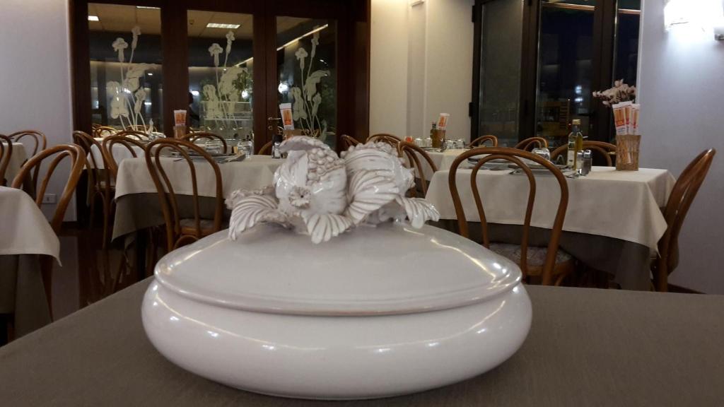 two birds sitting on a bowl on a table at Hotel Belvedere in Venice-Lido