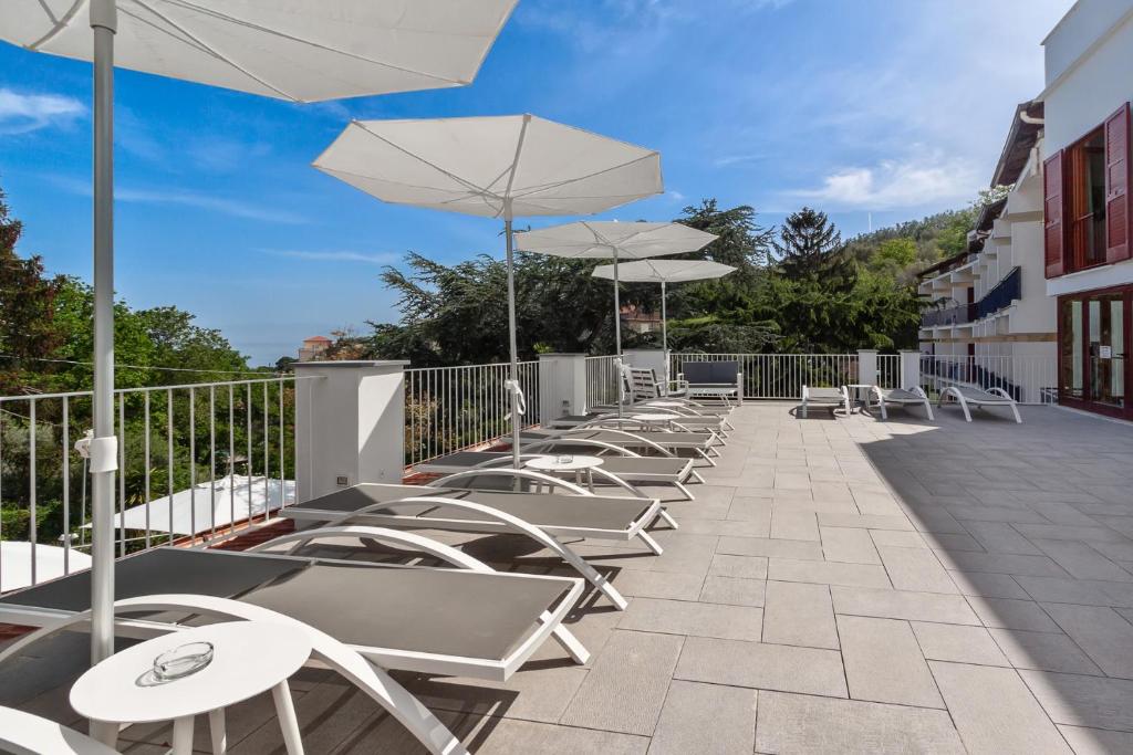 a row of chairs and umbrellas on a patio at Hotel Metropole in Sorrento