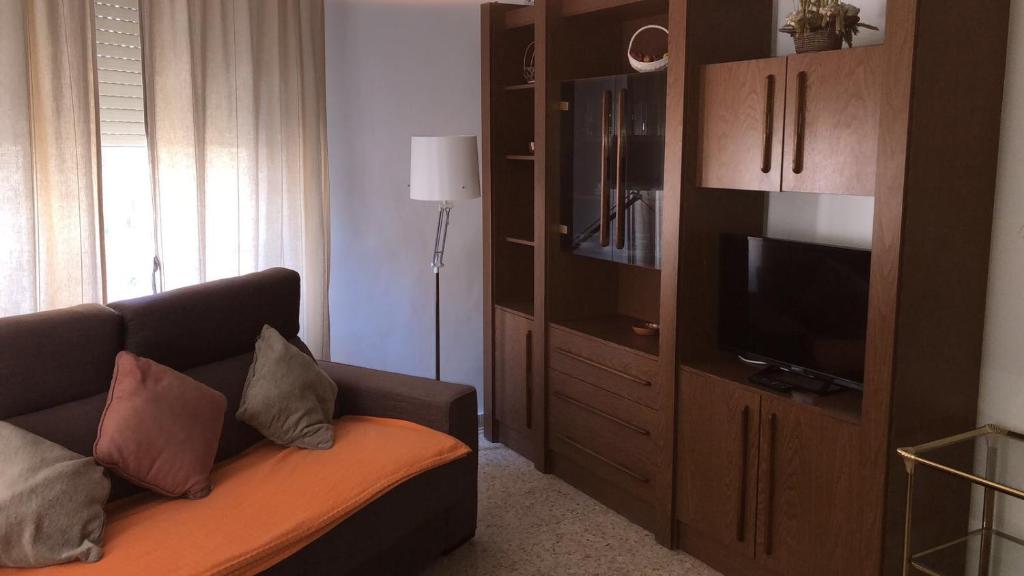 a living room with a couch and a flat screen tv at Apartamentos Calle Mayor in Castellón de la Plana