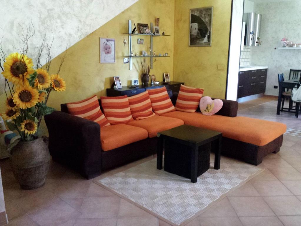 ein Wohnzimmer mit einem Sofa und orangefarbenen Kissen in der Unterkunft Casa Bellavista in Viggianello