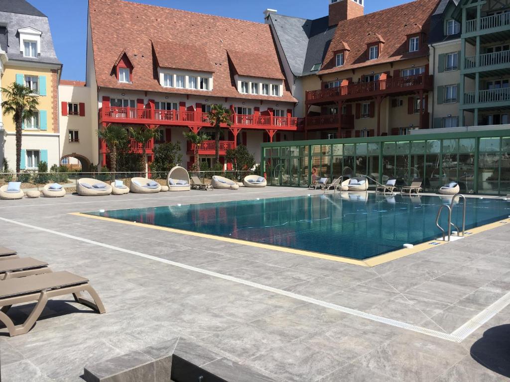 a swimming pool in the middle of a building at Cyrille et Vacances Presqu'ile de la Touques in Deauville