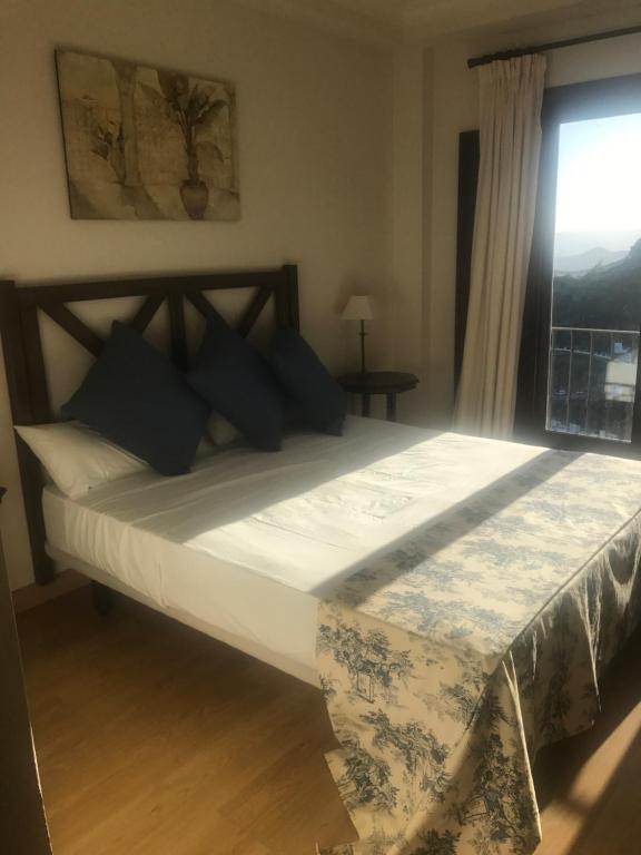 a large bed in a bedroom with a window at Villa 38 in Casares