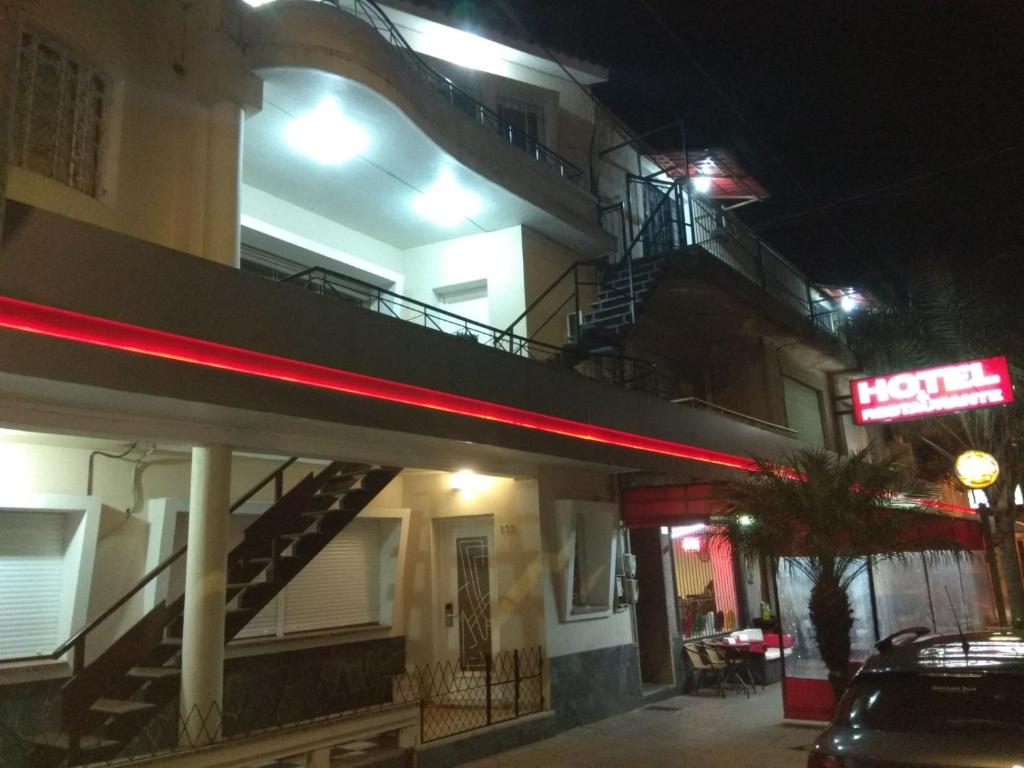 a hotel at night with a neon sign in front of it at Petit Rivera Hotel in Rivera