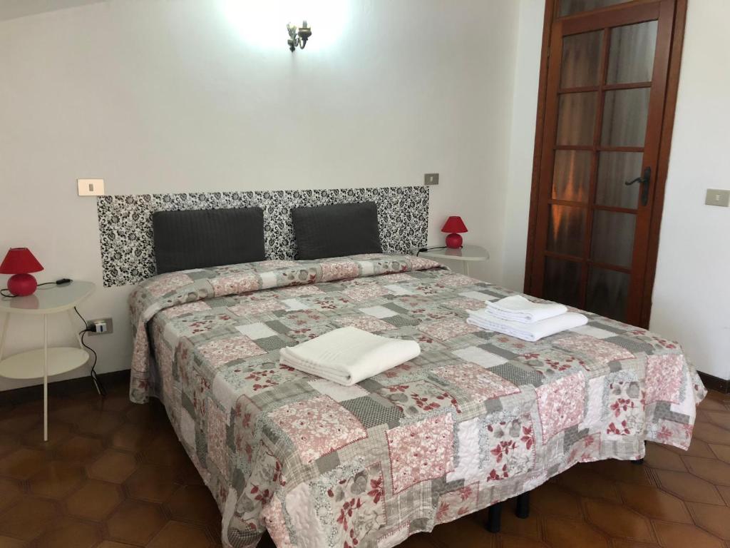 a bedroom with a bed with a quilt on it at Apartment La Terrazza in Orio al Serio