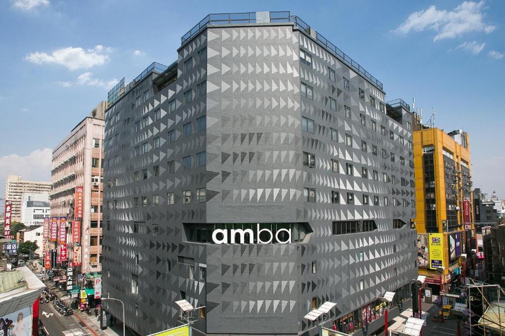 a building with an amoco sign on the side of it at amba Taipei Ximending in Taipei
