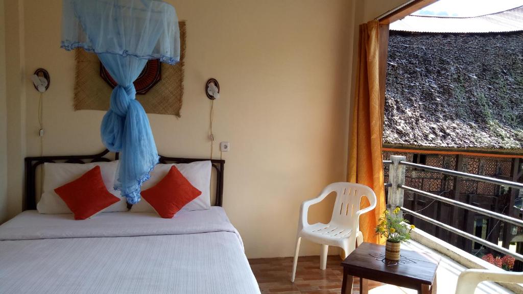 Postel nebo postele na pokoji v ubytování Rura Raya Homestay
