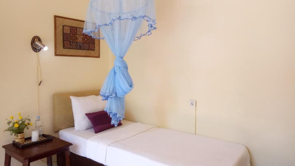 Postel nebo postele na pokoji v ubytování Rura Raya Homestay