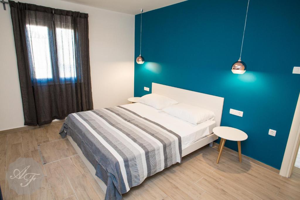 Posteľ alebo postele v izbe v ubytovaní Apartmani Ferdinanda