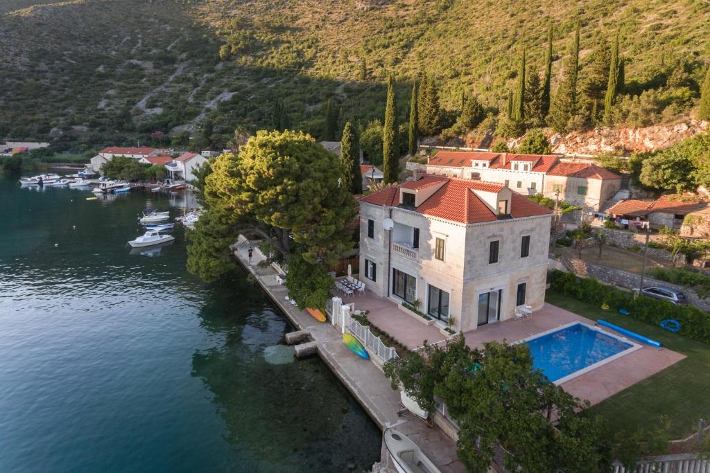 an aerial view of a house on the water at Villa Dubravka - heated outdoor pool and indoor jacuzzi in Zaton