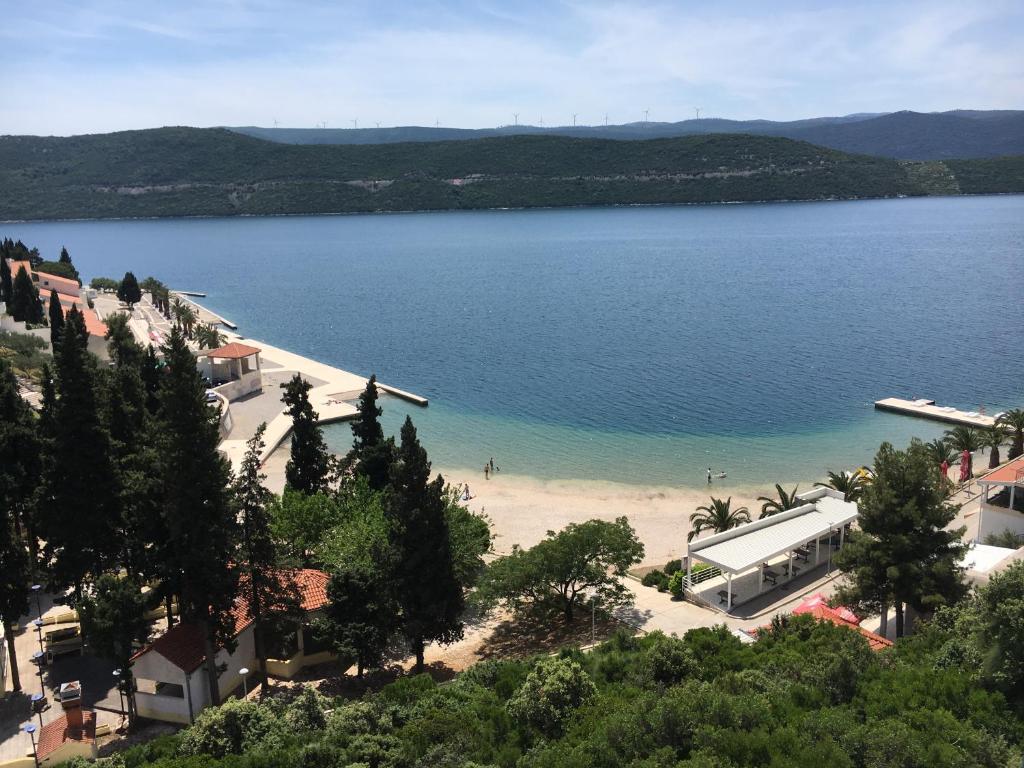 a view of a beach with a large body of water at Apartments Savić in Neum