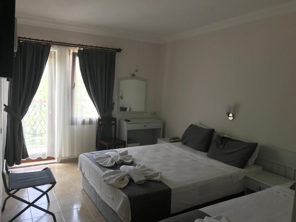 Postel nebo postele na pokoji v ubytování Kilim Hotel & Apart