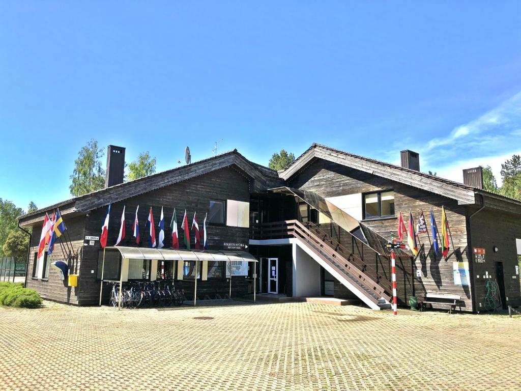 a building with flags on the side of it at Nidos kempingas in Nida