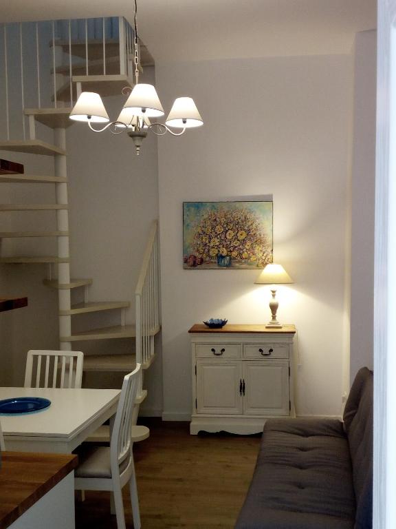a living room with a couch and a table and a staircase at Casa Mina in Monopoli