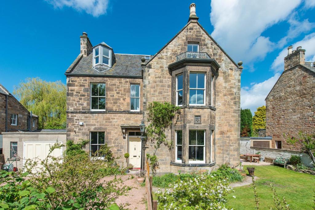 an old stone house with a turret at 3 Eskbank Terrace in Dalkeith