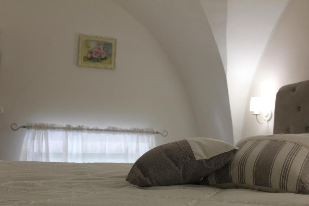 Łóżko lub łóżka w pokoju w obiekcie Dimora della Castellana