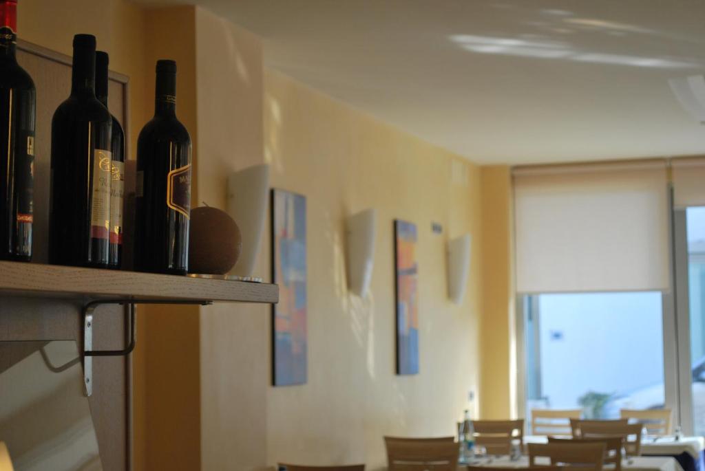 a room with bottles of wine on a shelf at Hotel Bologna in Lignano Sabbiadoro