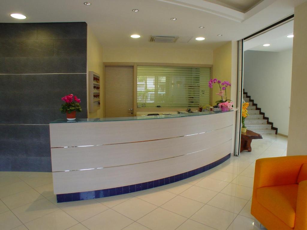 a lobby of a hospital with a reception counter at Hotel Bologna in Lignano Sabbiadoro