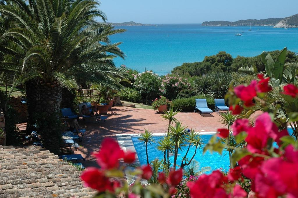 a resort with a pool and a view of the ocean at Residence Fenicia in Villasimius