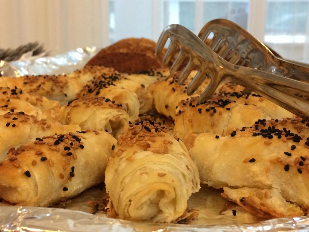 a plate of food with a fork on it at Marigold Otel in Çeşme