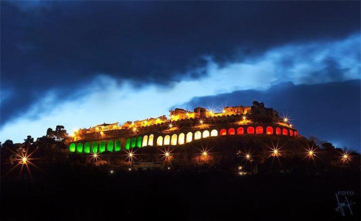 a bridge with lights on a hill at night at Porzione di villetta in Silvi Paese