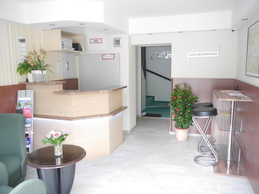 a waiting room with a counter and a table at Apart Pension Plaue in Brandenburg an der Havel