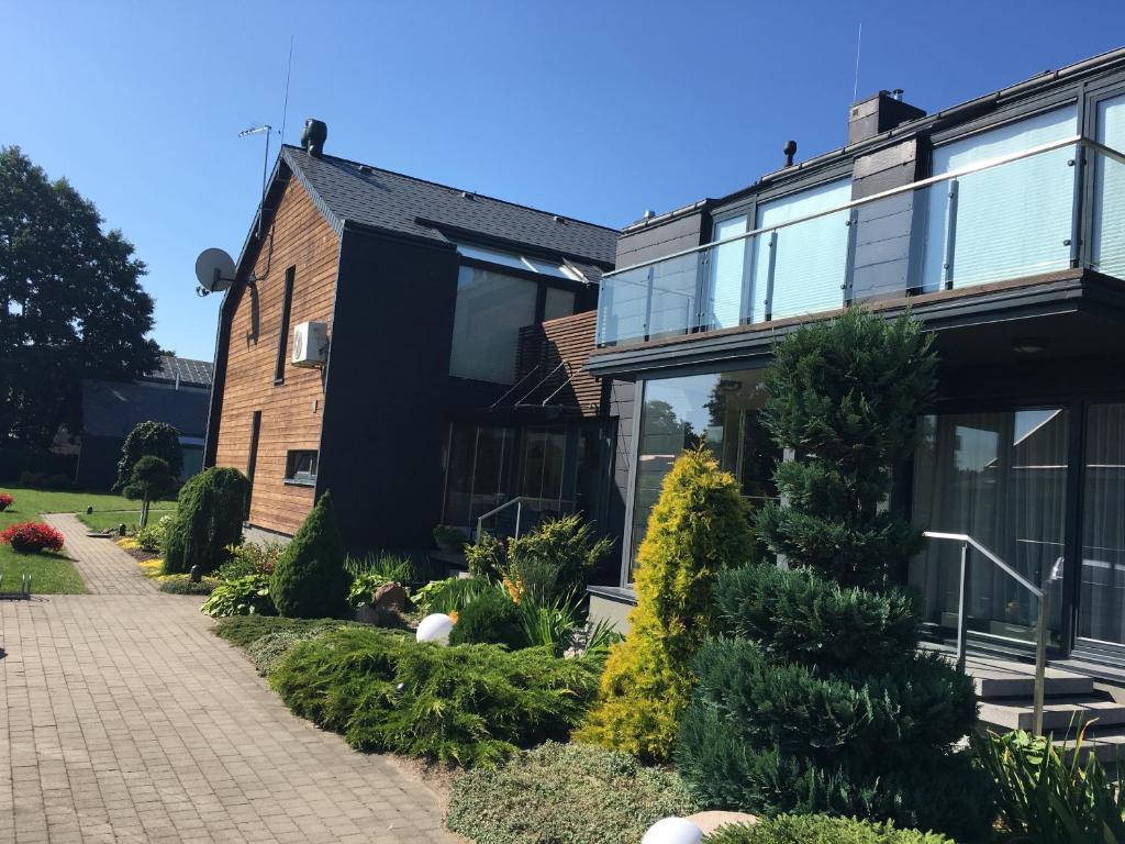 a house with a garden in front of it at Namai pas Gintarą in Palanga