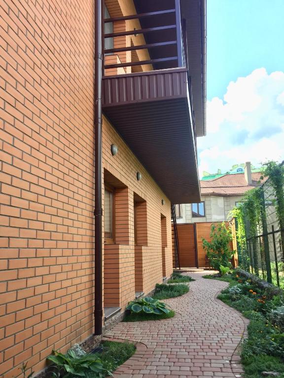 a brick building with a balcony on the side of it at Uytno in Chornomorsk
