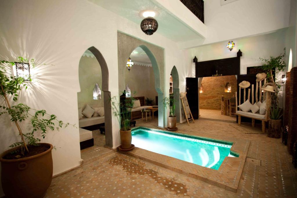 a large room with a swimming pool in a house at Riad Shambala in Marrakesh