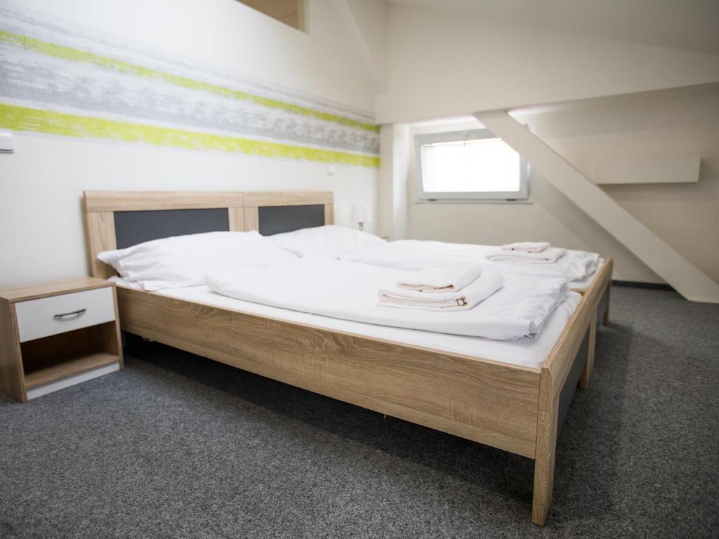 ein Schlafzimmer mit einem großen Bett mit weißer Bettwäsche in der Unterkunft Apartment Pulse Fitness in Benešov