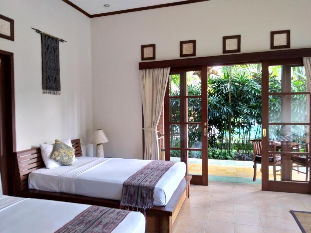 Postel nebo postele na pokoji v ubytování Ubud Lestari Bungalows