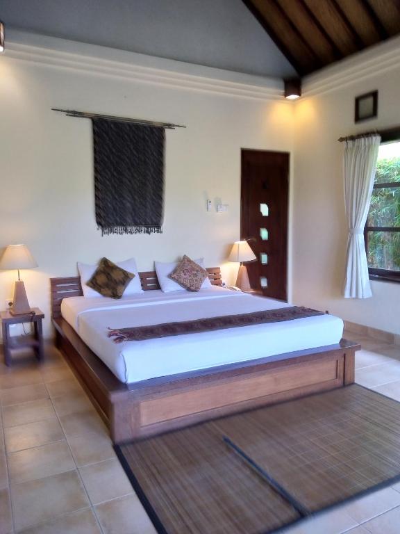 Postel nebo postele na pokoji v ubytování Ubud Lestari Bungalows