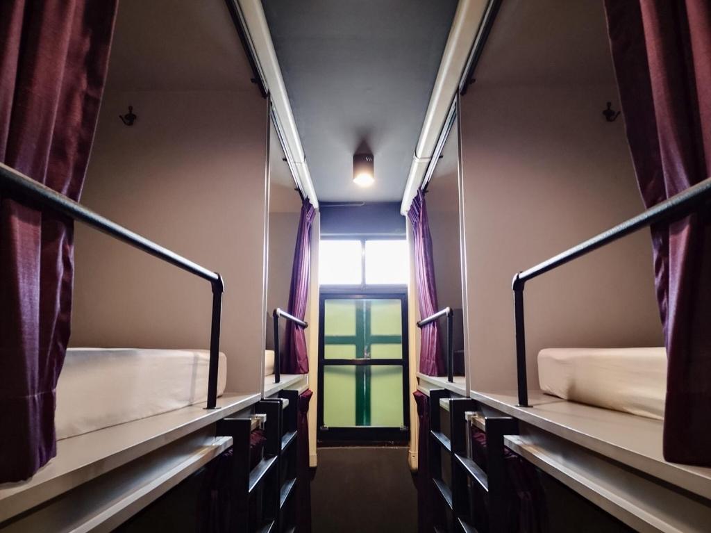 Giường trong phòng chung tại Tian Tian Hostel