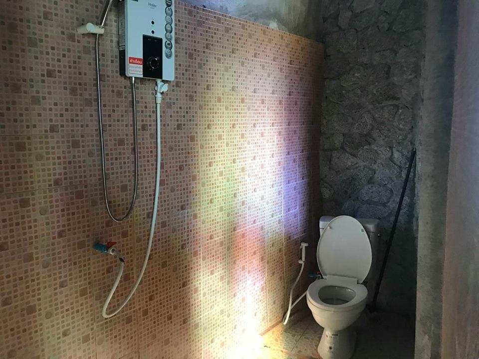 a bathroom with a shower with a toilet in it at Farm stay 1000 Chang Valley in Ban Chak Phai