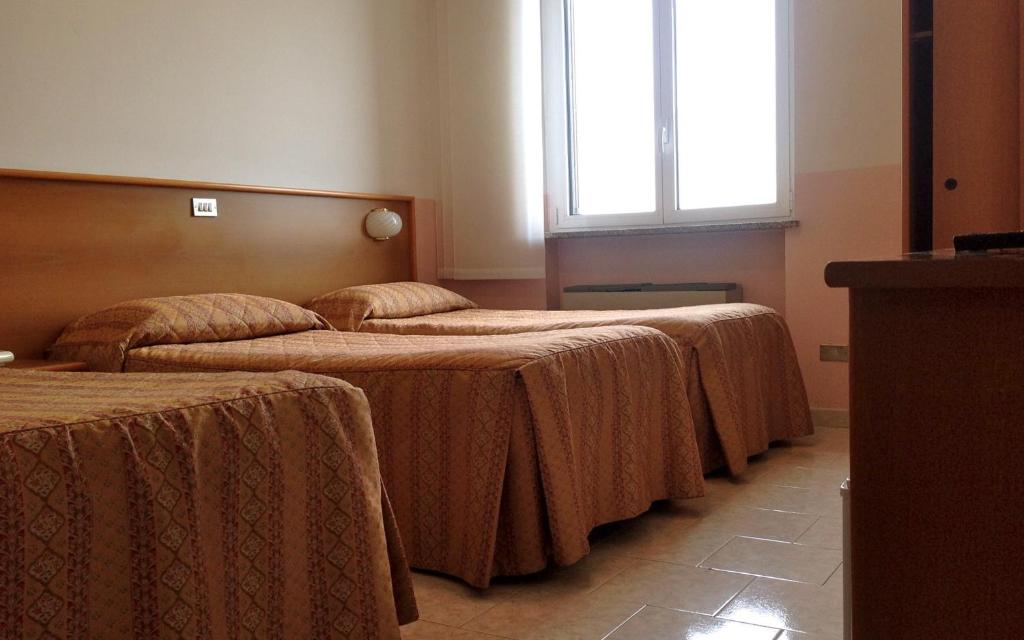 Postel nebo postele na pokoji v ubytování Hotel Monumento