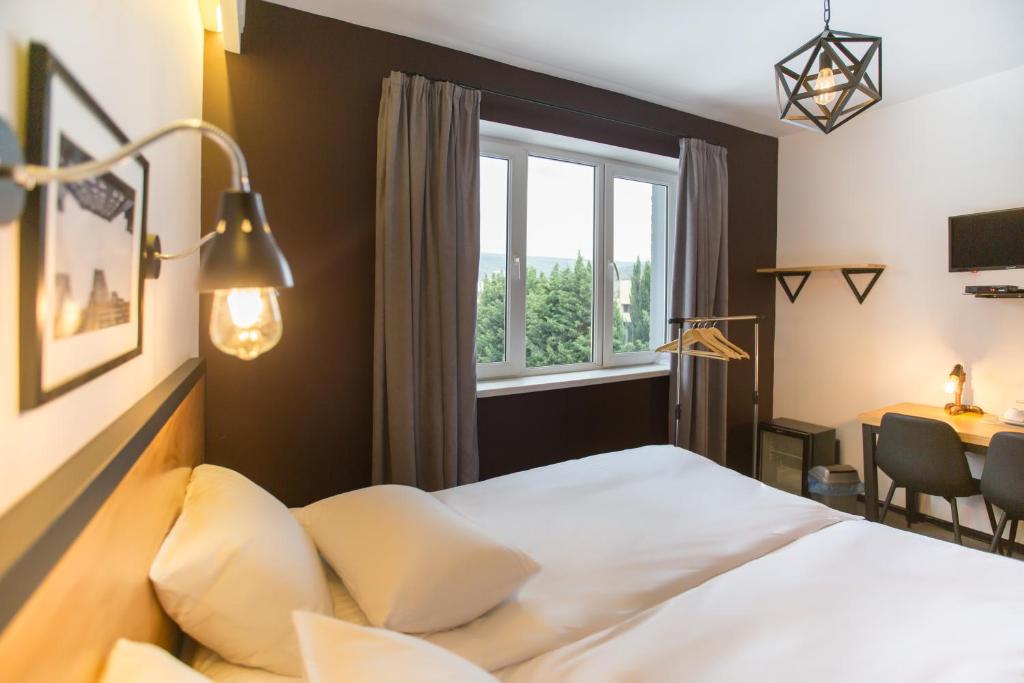 Postel nebo postele na pokoji v ubytování Timber Boutique Hotel
